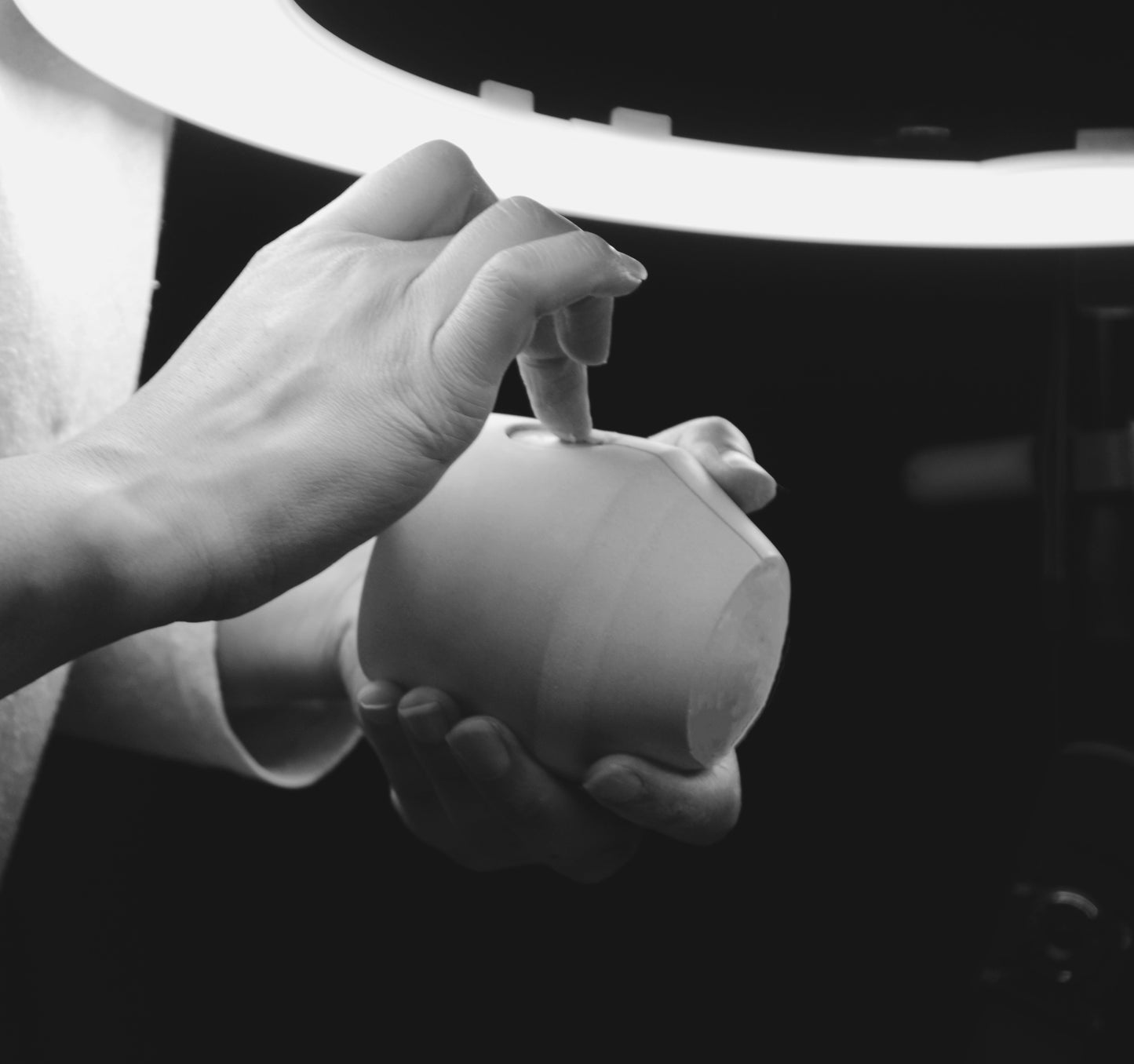 Nikki, our founder, inspecting the finish of a production case Luna jar. Black and white image.