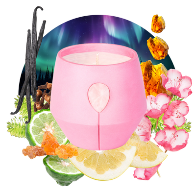 Image of Luna Amber Oro candle with its scent collage at the back - the text reads: Harmonize with Opoponax and White Grapefruit adorned with Rose Quartz in our invigorating pink vessel. This scent refreshes your space with positive energy and tranquility with soft citrus notes. 