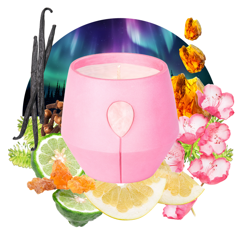 Image of Luna Amber Oro candle with its scent collage at the back - the text reads: Harmonize with Opoponax and White Grapefruit adorned with Rose Quartz in our invigorating pink vessel. This scent refreshes your space with positive energy and tranquility with soft citrus notes. 